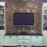 TV mounted on brick wall